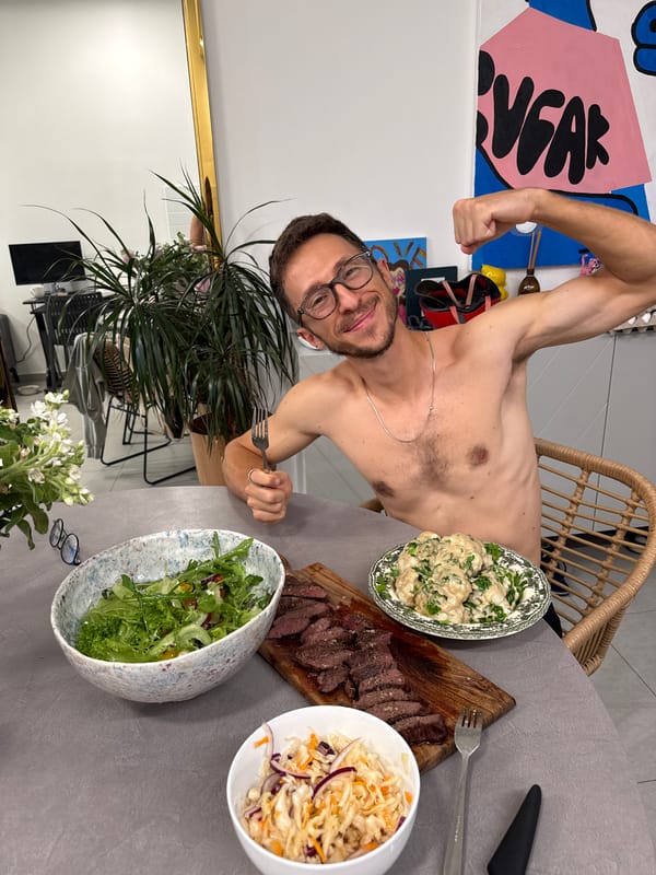 Man poses with meal spread in Givatayim