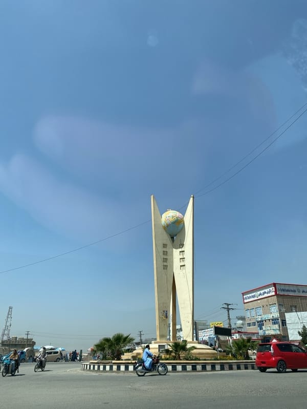 Traffic officer patrols Kandahar roundabout with globe monument