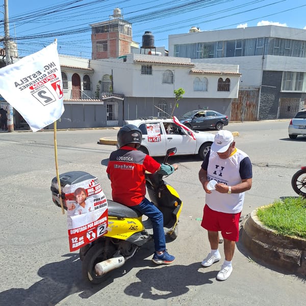 Man on scooter displays campaign materials on city street
