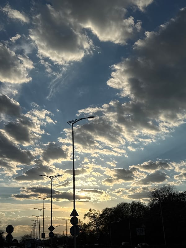 Dramatic storm clouds and sunset captured over urban street