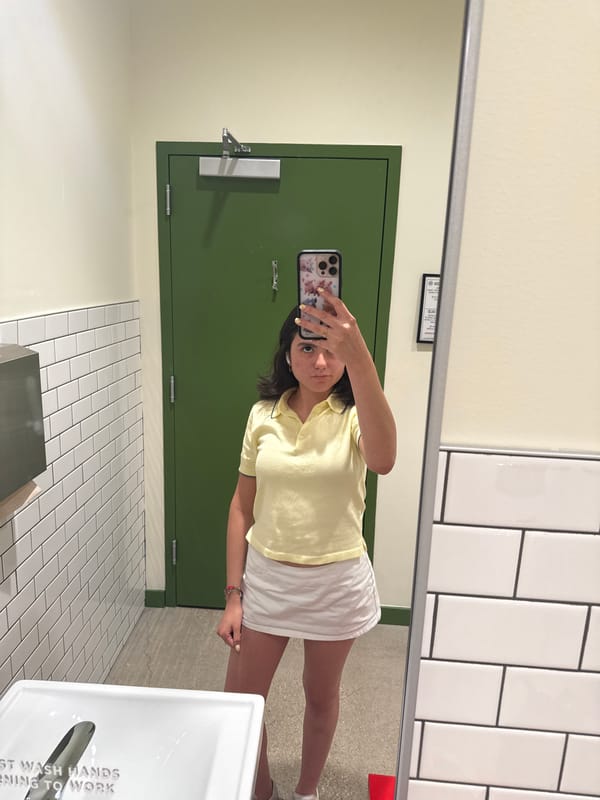 Woman takes selfies in Austin restroom during evening outing