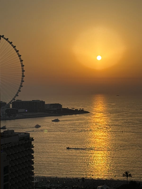 Golden hour over Dubai's waterfront, watched from a high-rise