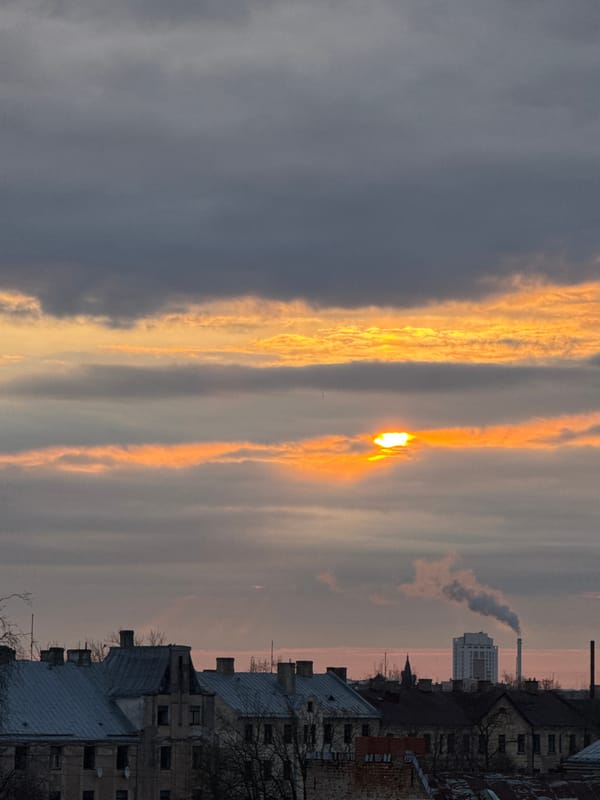 Orange sunset glow captured over Riga cityscape