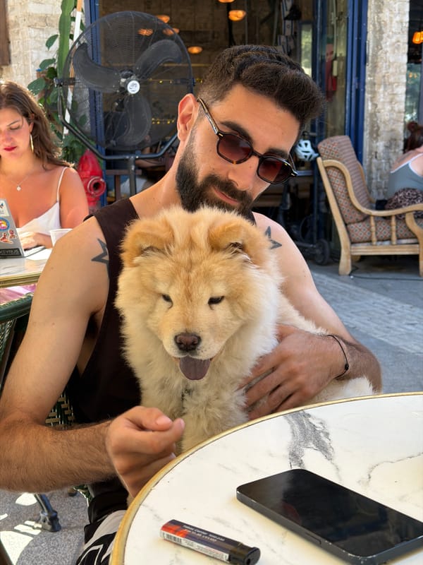 Man shares tender moment with Chow Chow at Tel-Aviv cafe