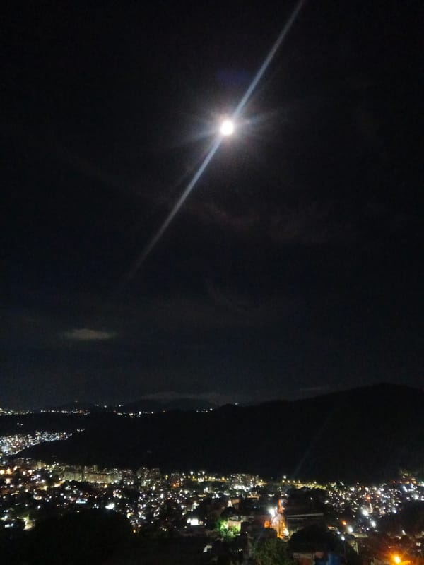 Caracas glows at night under a full moon