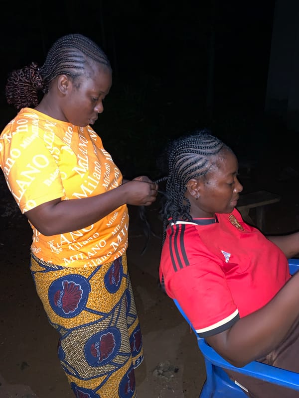 Evening hair braiding session outdoors in Akwanga, Nigeria