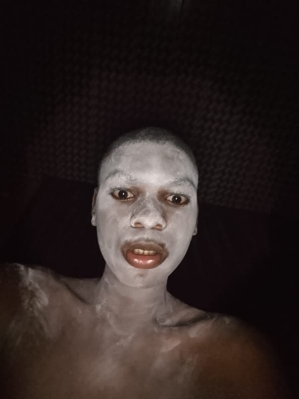 Person photographed covered in white powder substance indoors