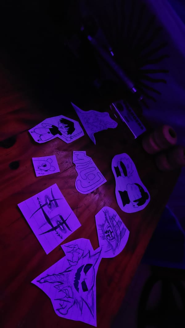 Cartoon drawings found on wooden surface under purple light