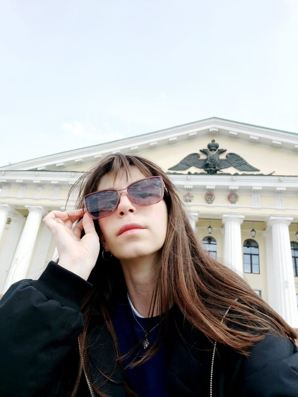 Woman photographed at classical building and waterfront location