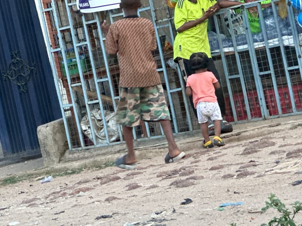 Children gather near metal structure in brief afternoon encounter