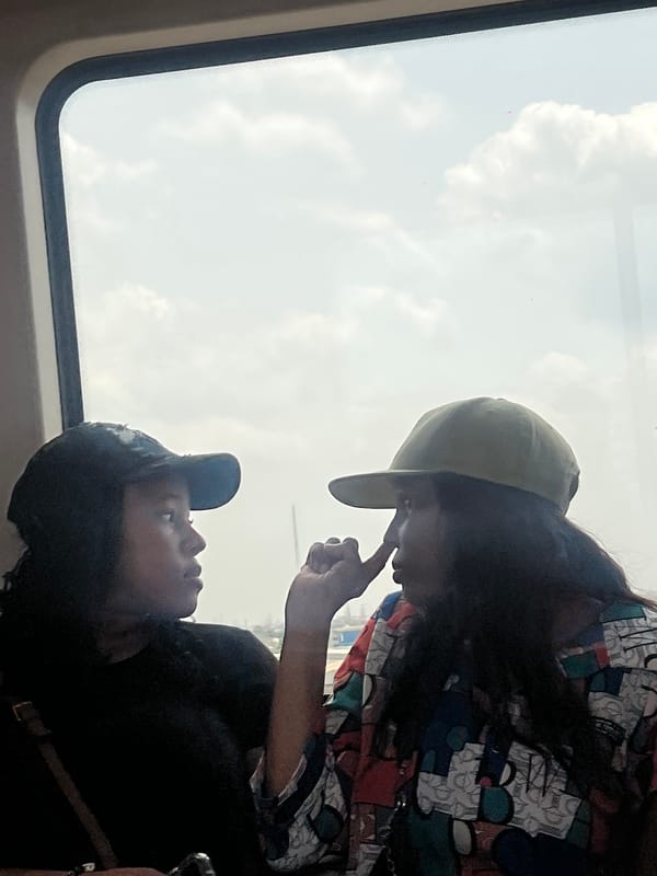 Two people share moment by window in Lagos