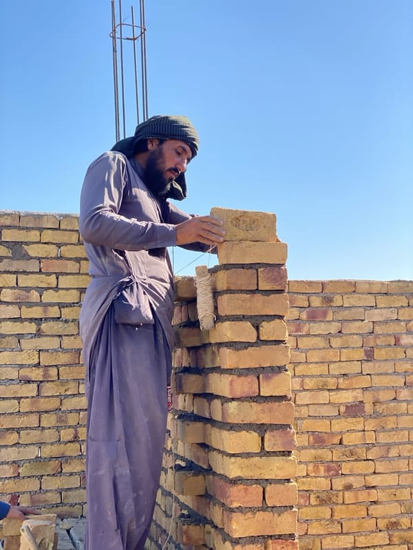Construction workers build brick walls in Kandahar, Afghanistan