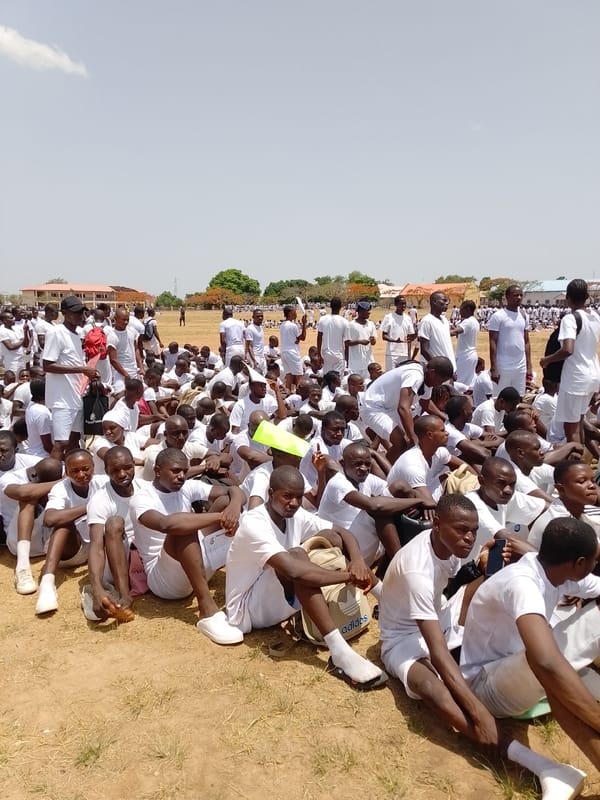 Large outdoor gathering observed on dusty field April 28