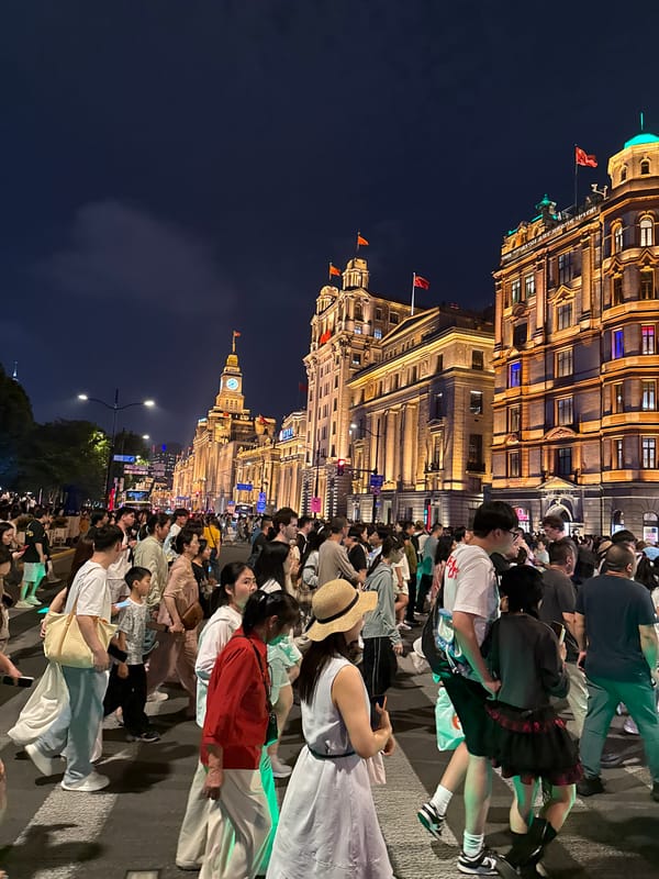 Nighttime crowds fill Shanghai's illuminated commercial districts