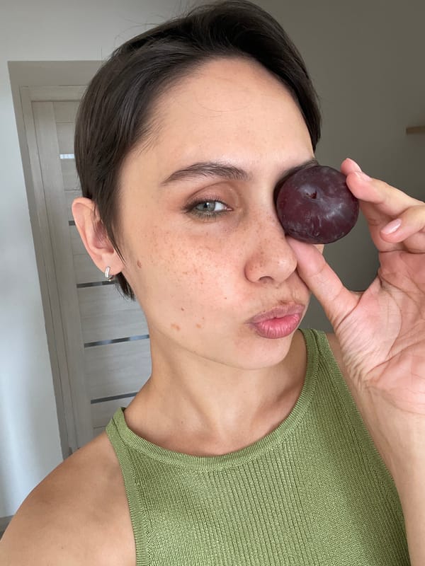 Woman photographed with plum against face in Izhevsk
