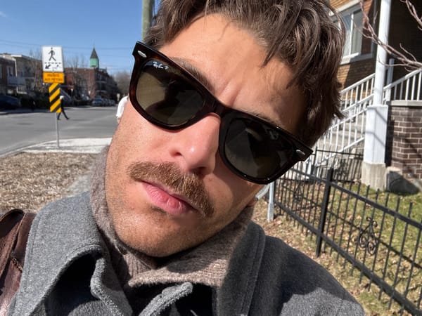 Man takes multiple selfies outdoors in Montreal