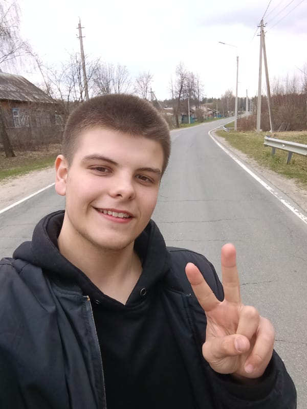 Young man takes selfies on rural road in Russia