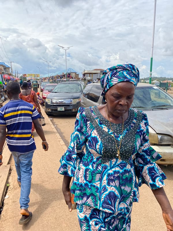 Afternoon foot traffic and street commerce in Bukuru, Nigeria