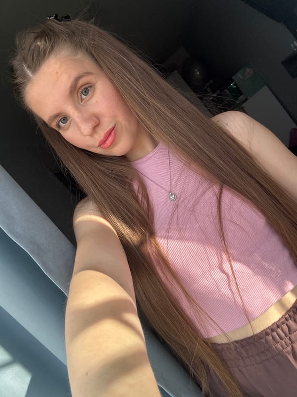 Woman takes selfies in pink top in Klin, Russia
