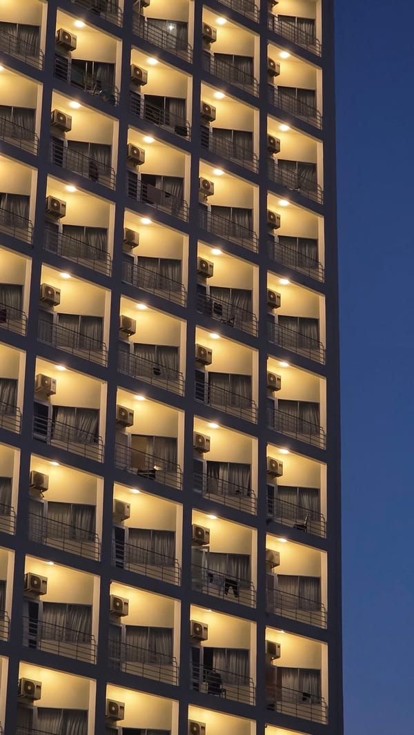 Evening lights illuminate Nha Trang buildings during twilight hours