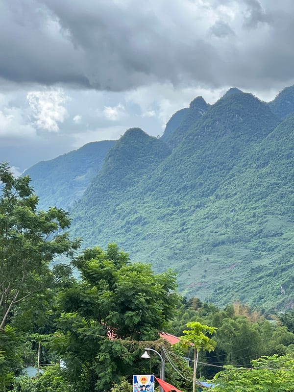 Rural mountain scenery along a winding road in Lũng Tám, Vietnam