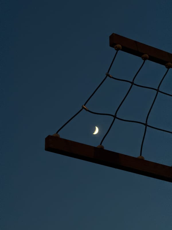 Net structure with wooden frame observed against evening sky