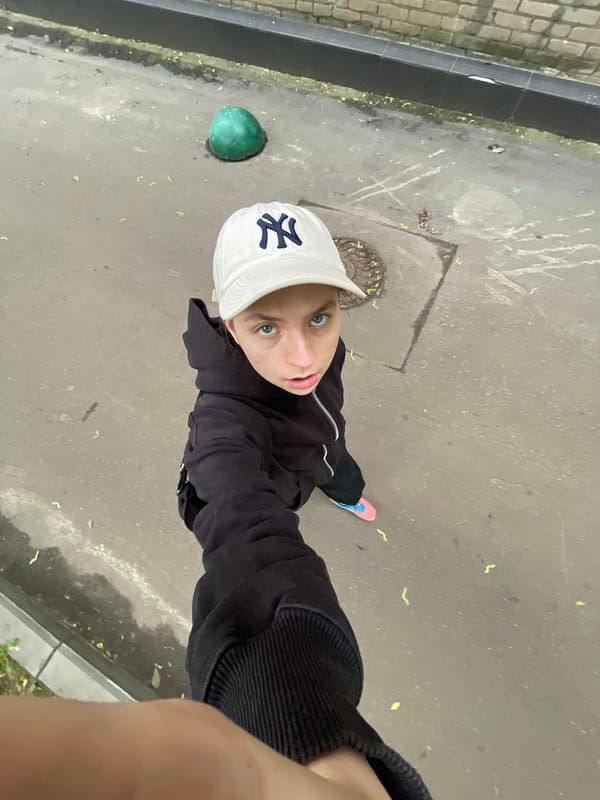 Person in NY cap photographed on Moscow street early morning