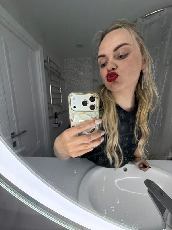 Woman takes selfies while applying makeup in Votkinsk