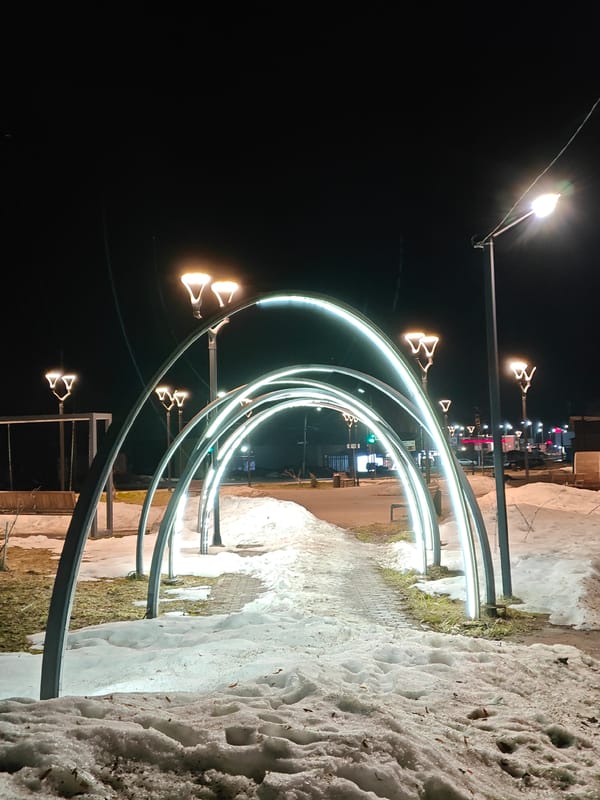 Nighttime pedestrian walkway illuminated in Chaikovsky park