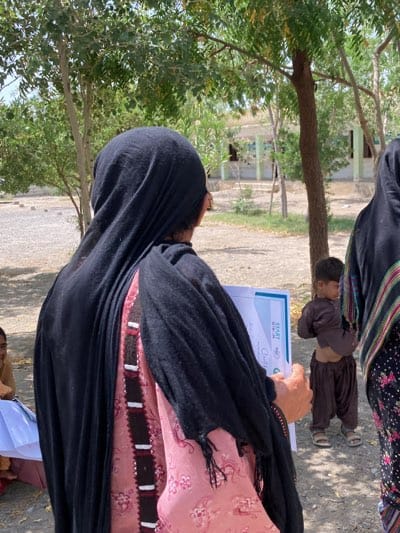 Women gather with certificates in Wayara Pakistan community event