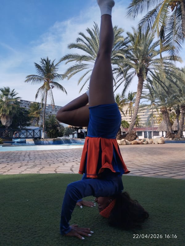 Person performs acrobatic handstands and backbends on artificial turf