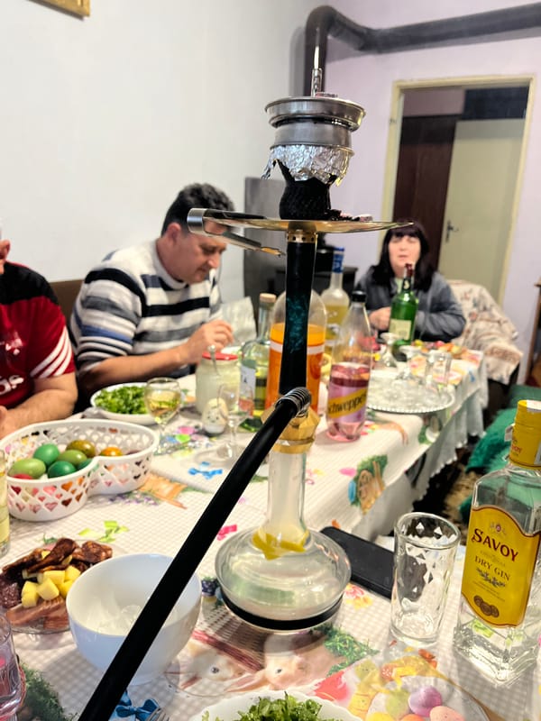 Three people gather around hookah in Pamukchii, Bulgaria