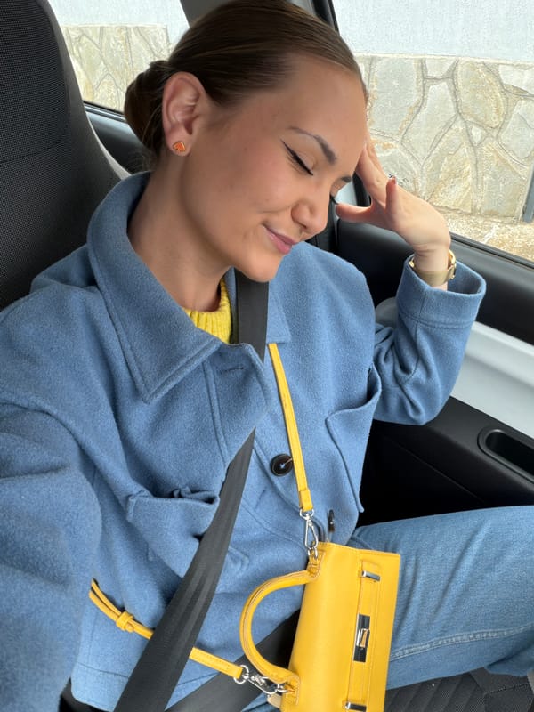 Woman rests in car while listening to music in Buhovo