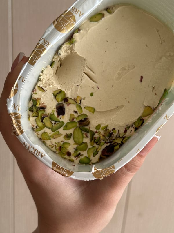Person enjoys pistachio halva snack in Chaikovsky, Russia