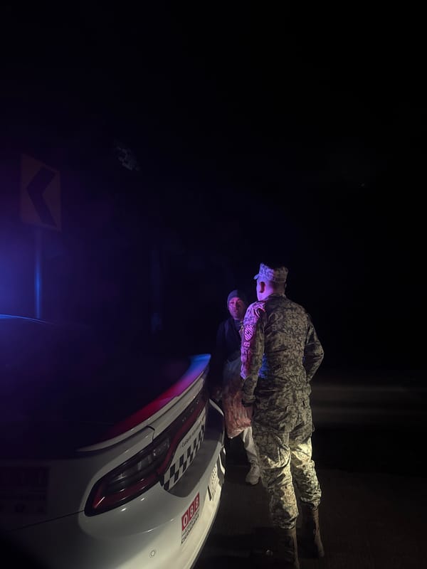 Military figure observed with civilian near vehicle in Mexico
