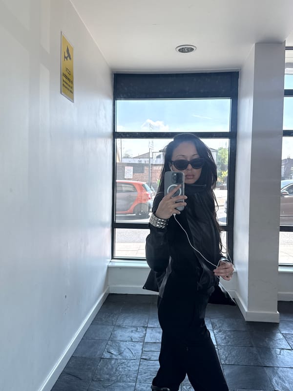Woman takes mirror selfie in modern London building
