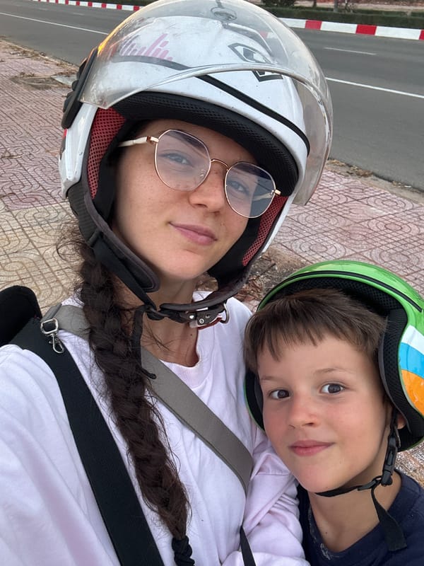 Woman and boy pose for photo in helmets, Mui Ne
