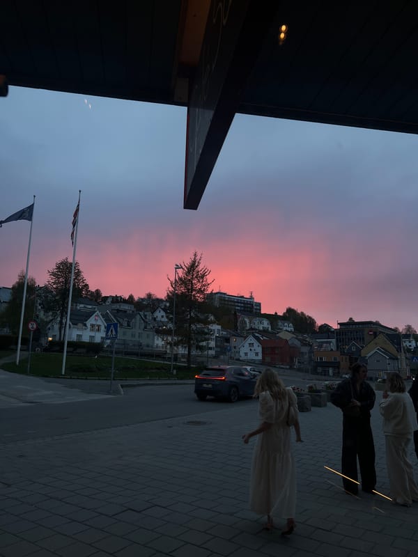 Twilight street life captured across Tromsø during evening hours