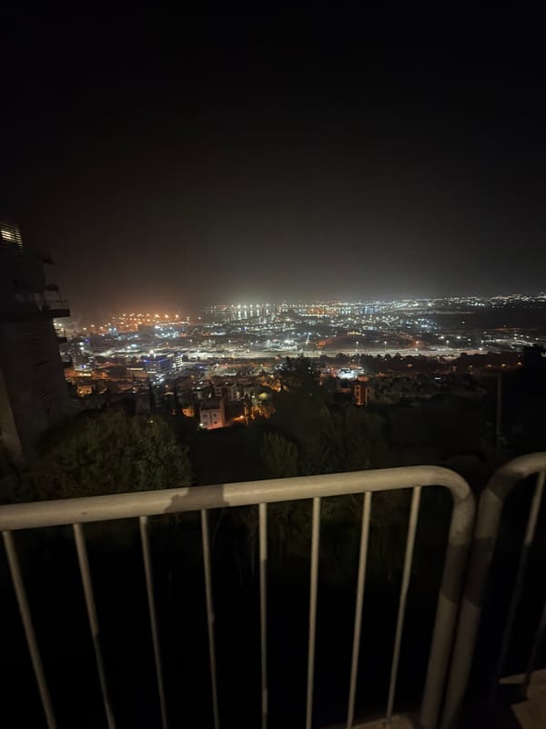 Nighttime aerial view captured of illuminated Haifa cityscape
