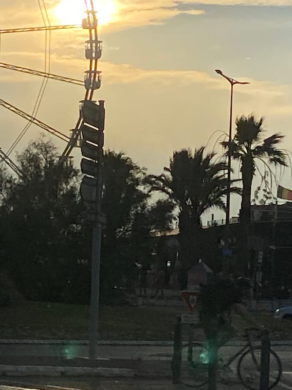 Ferris wheel and city streets at hazy sunset
