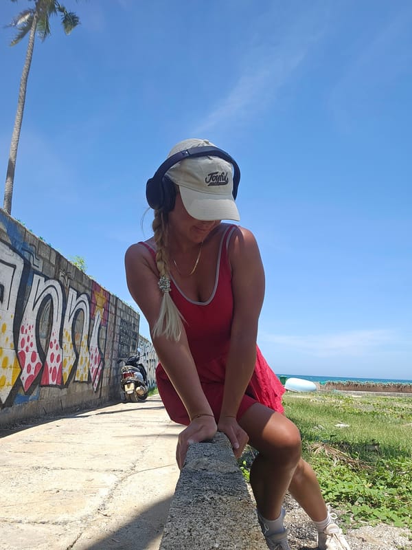 Red dress and graffiti wall: posing in Phu Thuy Ward
