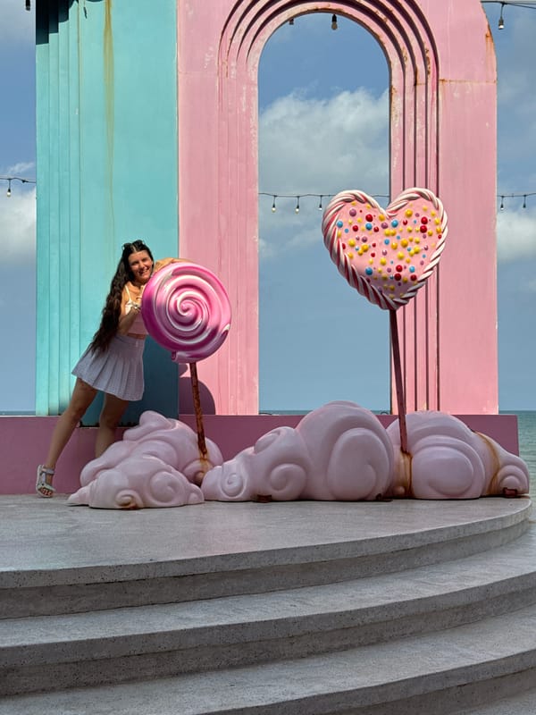 Woman poses at whimsical Pinky Garden candy installation in Vietnam