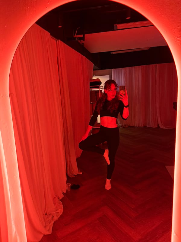 Woman takes selfie in red-lit room in Moscow