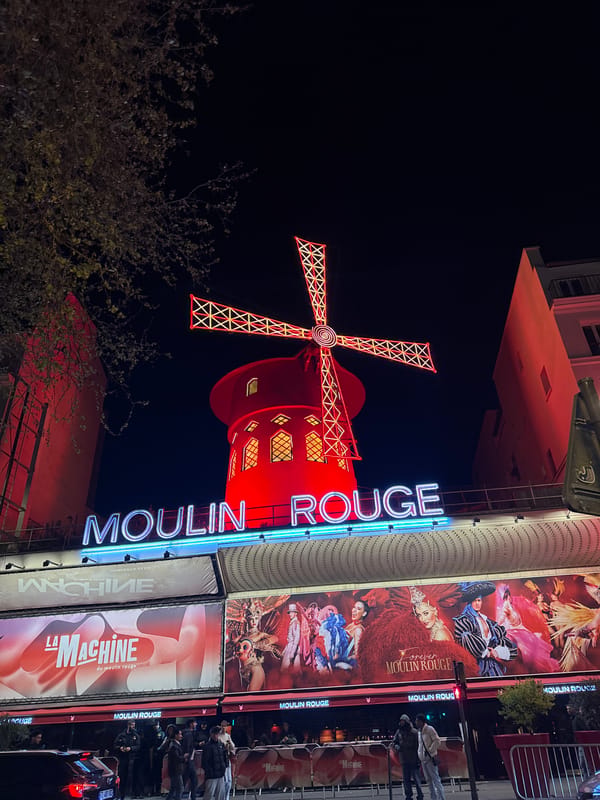 Moulin Rouge illuminated at night in Paris