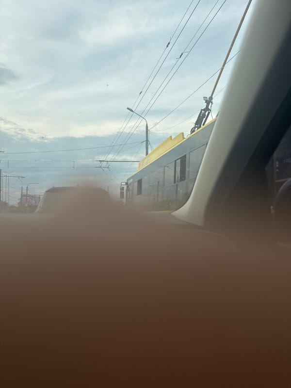 Driver Documents Street View Through Passenger Window, Finger Blocks Lens