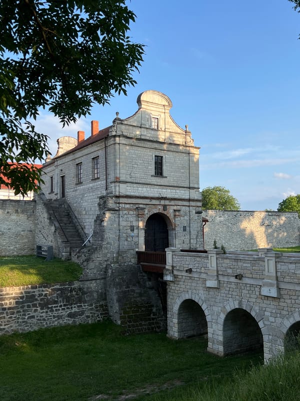 Tourist documents historic Zbarazh Castle during sunny afternoon visit