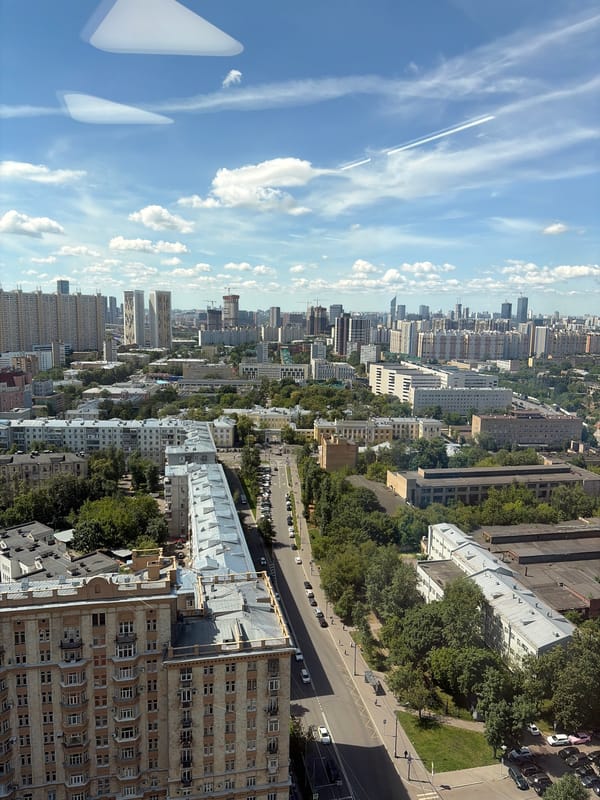 High-altitude aerial view over a dense city below