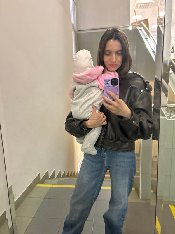 Woman photographs herself with baby in Moscow mirror