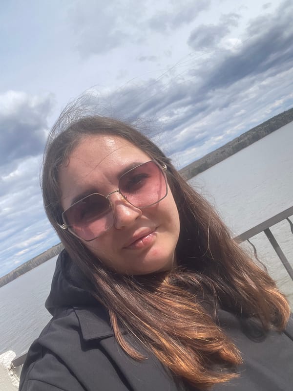 Woman takes selfies along Chaikovsky waterfront during morning outing