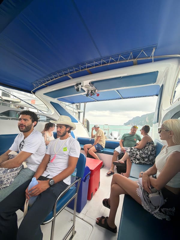 Ao Nang harbor morning: boats, divers, and dockside cats